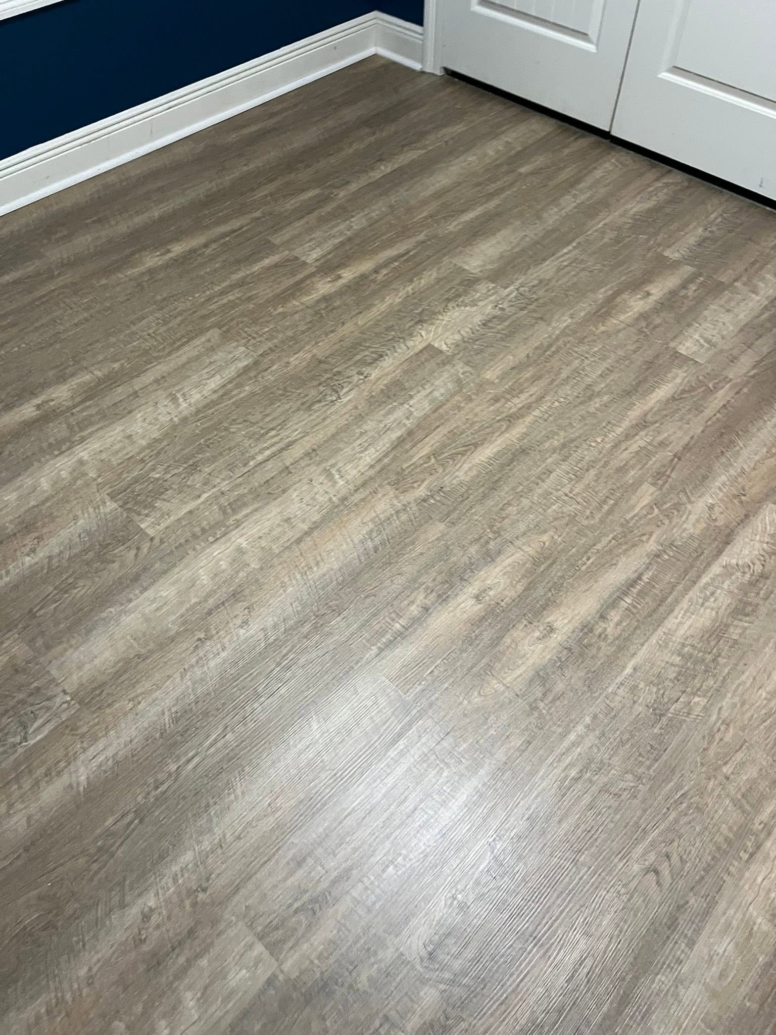 Detailed view of finished gray plank flooring
